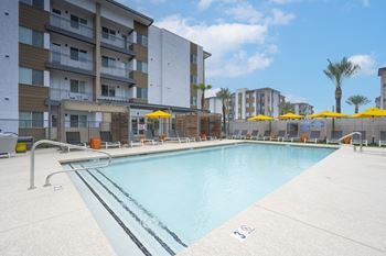 a swimming pool with a building in the background